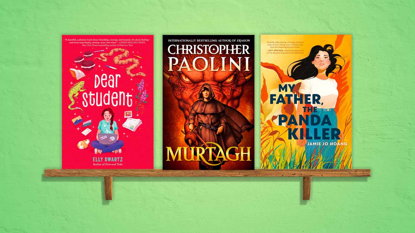 three books on a wooden shelf.