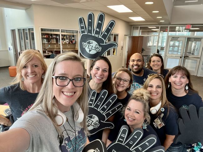 Spirit Week Ideas: High Five Friyays School staff wearing large foam hands with the school logo on them (School Spirit Week Ideas)