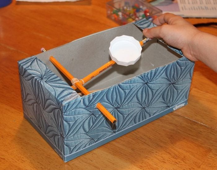 Third Grade Science Catapult Frugal Fun Tissue box modified with pencils and rubber bands to create a toy catapult