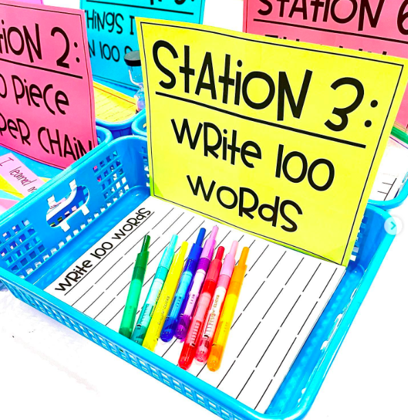 100th-day-writing-station A colorful bin with the label: "Station 3 Write 100 Words" holds writing paper and colored pens